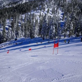 Custom feather flags flying at a snowy Colorado ski resort base area